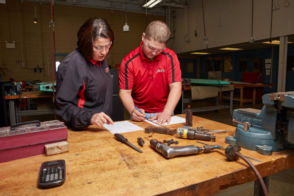 SGTC aviation maintenance lead instructor Victoria Herron works with students in the Griffin B. Bell Aerospace Technology Center.