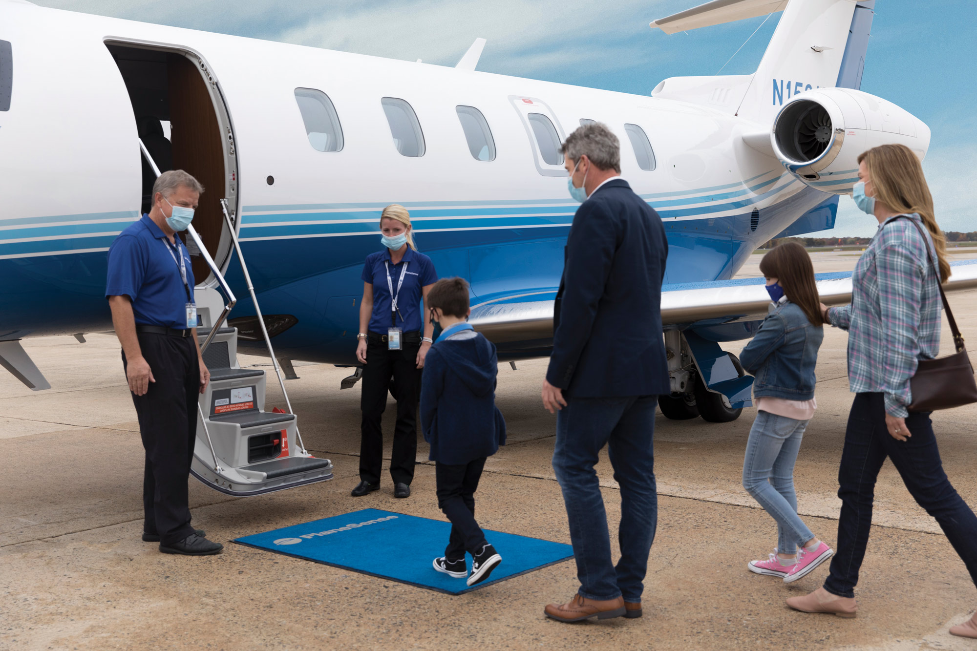 People boarding a business jet.