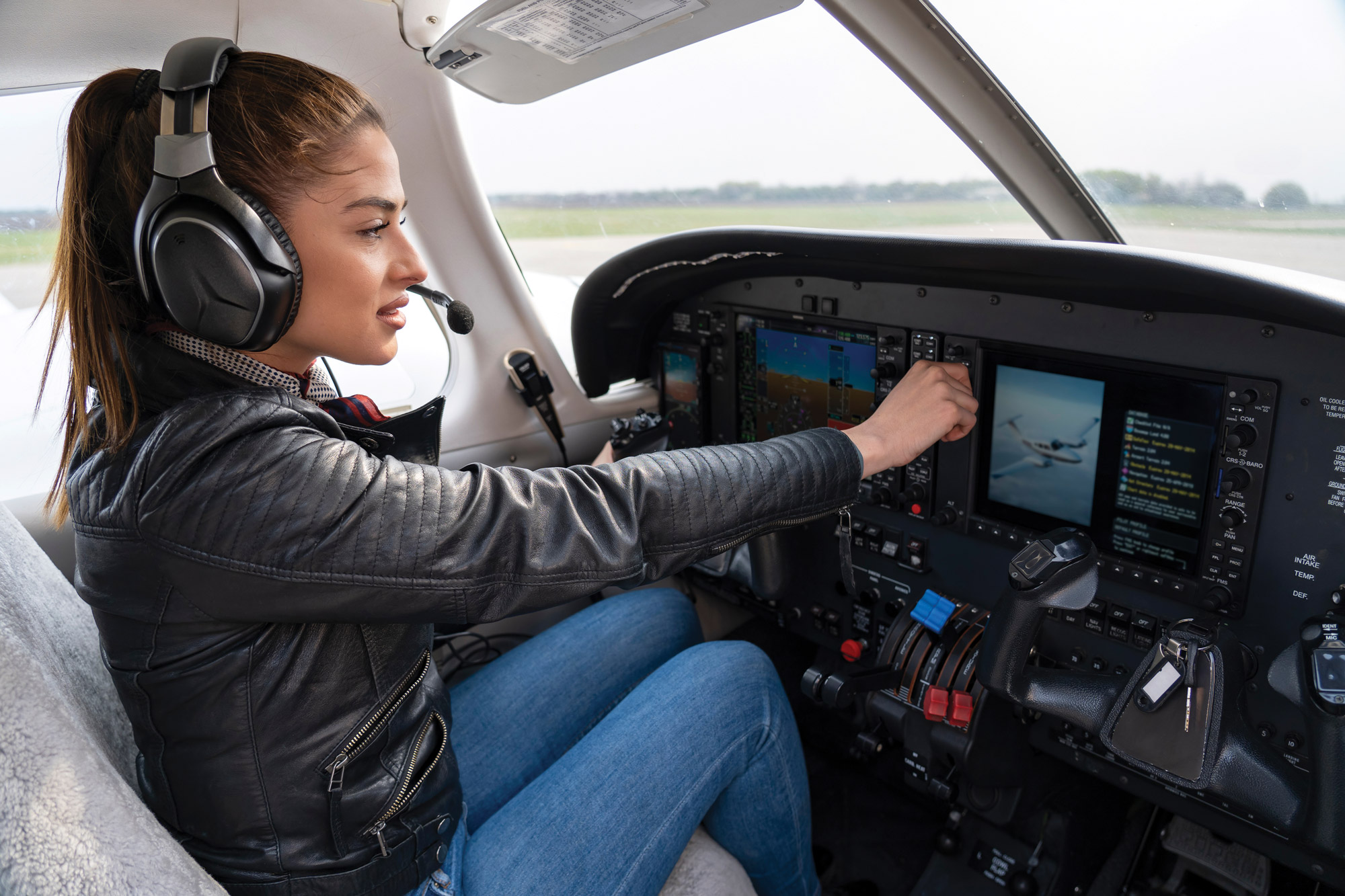 Woman Pilot With Headset in the Cockpit.